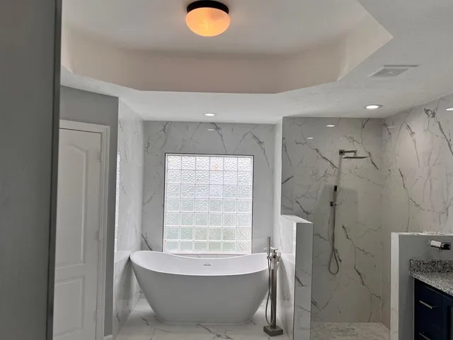 a bathroom with a tub and shower