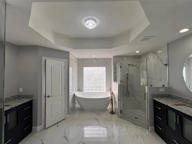 a spacious bathroom with a shower sink and mirror
