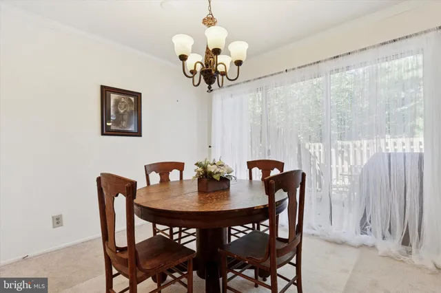 a dining room with furniture and chandelier