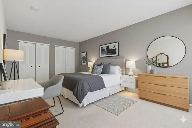 a bedroom with bed and a chandelier