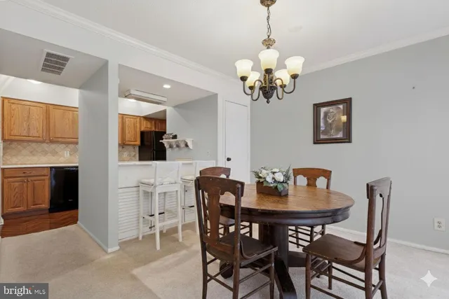a view of a dining room with furniture and chandelier