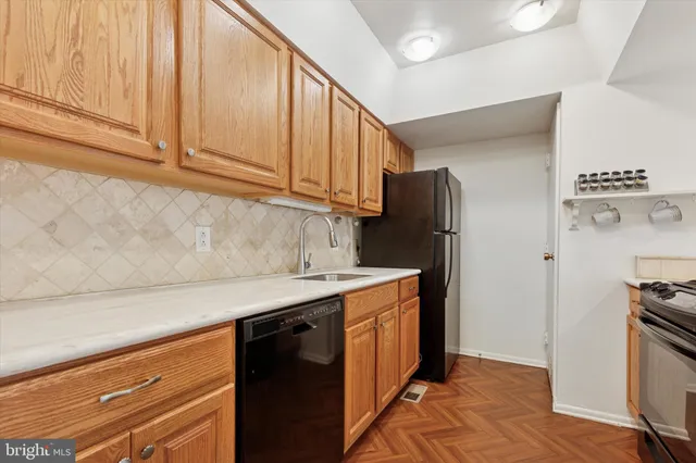 a kitchen with stainless steel appliances granite countertop a refrigerator and a stove