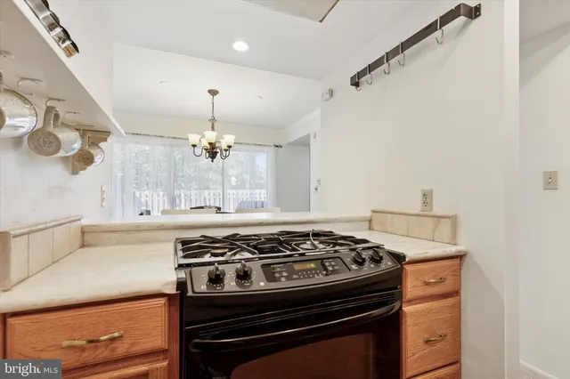 a white stove top oven sitting inside of a kitchen