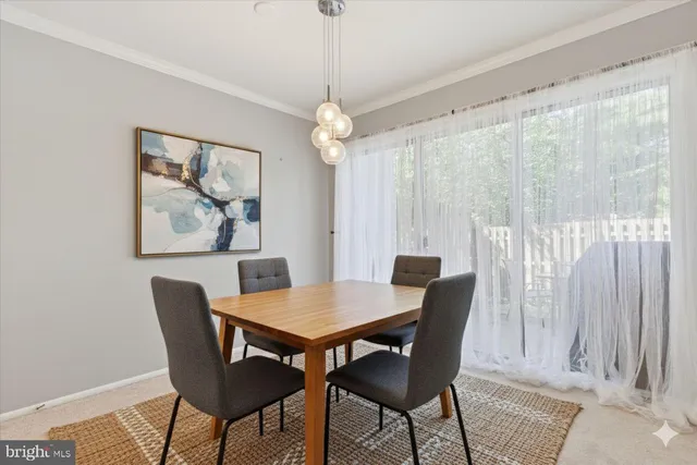 a dining room with furniture a chandelier and wooden floor
