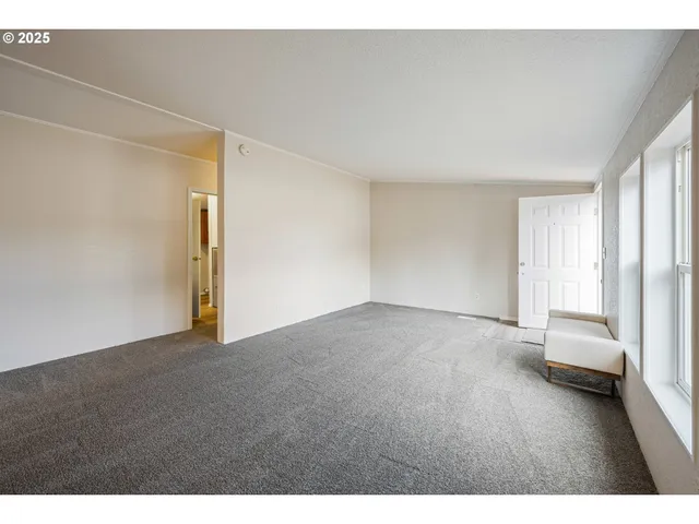 a view of an empty room and a window