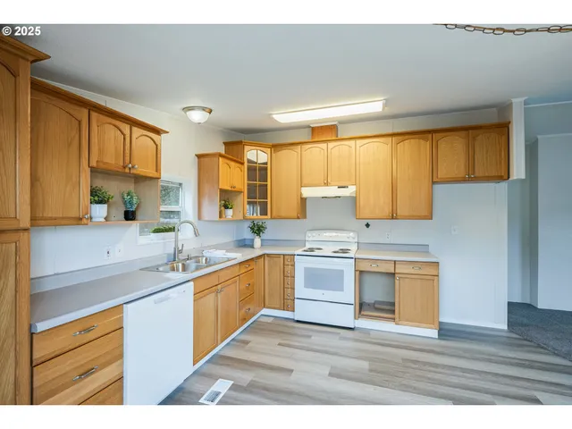 a kitchen with stainless steel appliances granite countertop a sink stove and cabinets