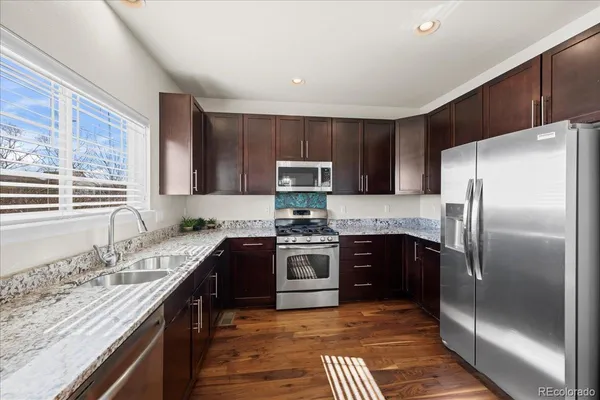 a kitchen with a sink stove and refrigerator