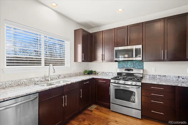 a kitchen with a sink stove and microwave