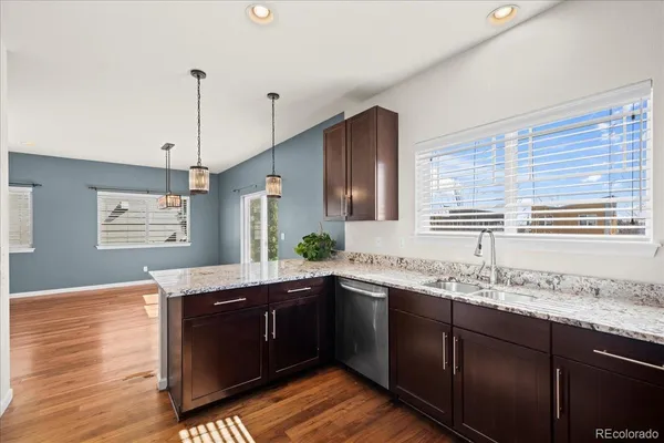 a kitchen with granite countertop cabinets sink and window