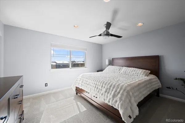 a bedroom with a large bed and a window