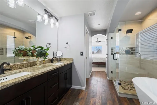 a spacious bathroom with a granite countertop sink and a mirror