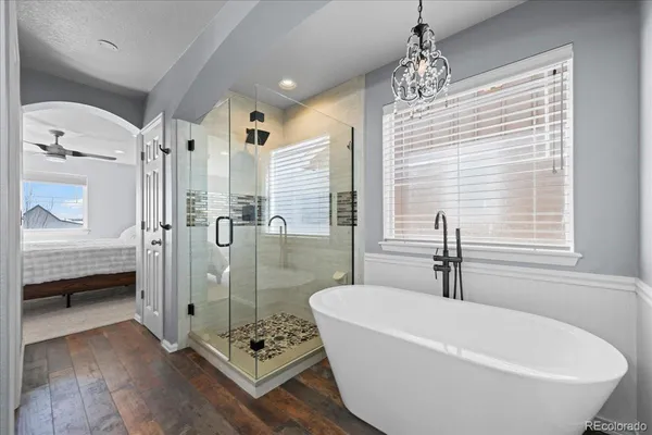 a white bath tub sitting next to a bathroom