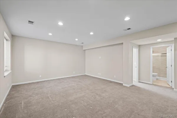 an empty room with entrance and windows
