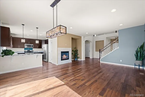 a view of a kitchen with furniture and wooden floor