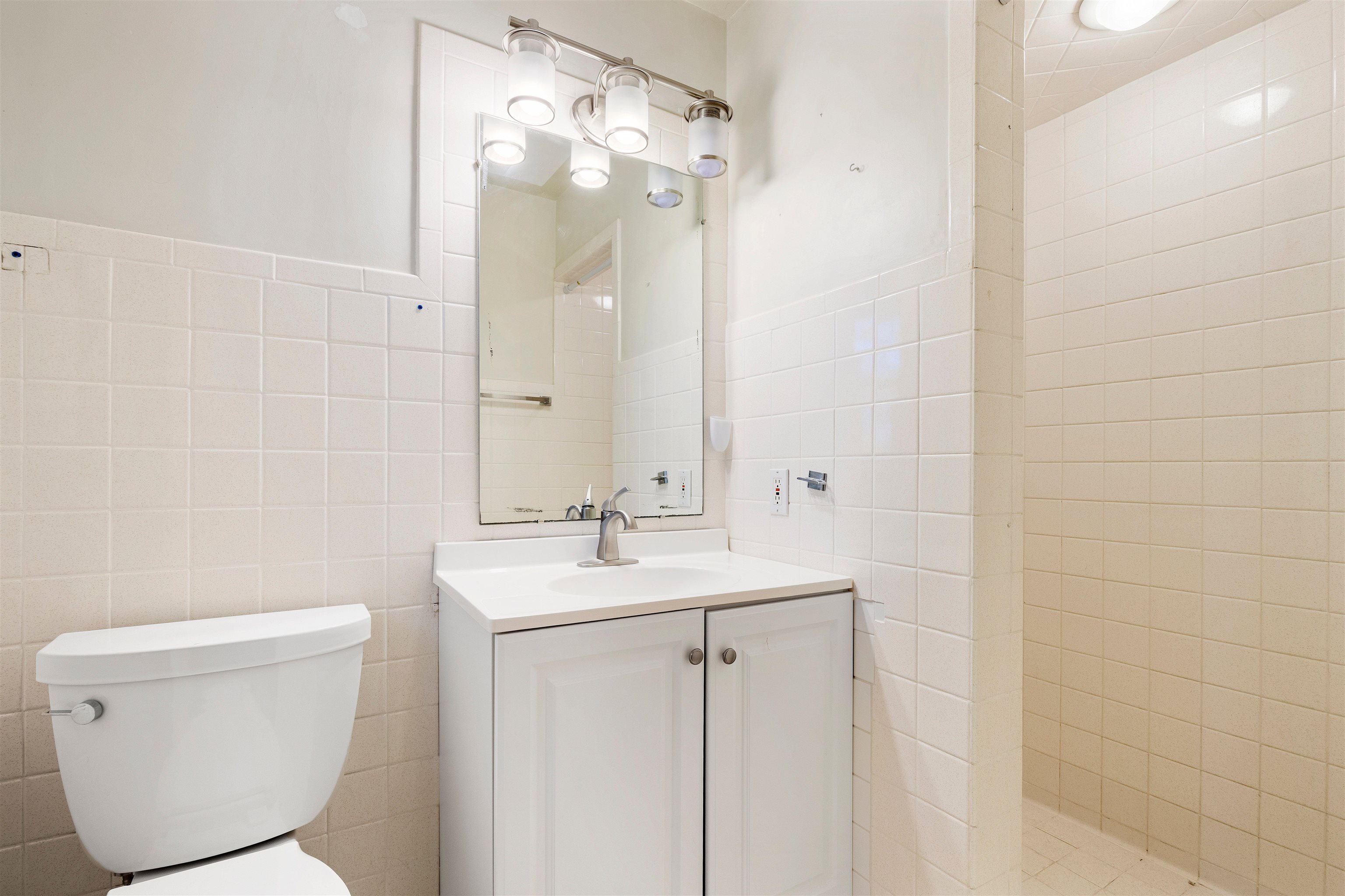 4962 Braewild Road Rockford, IL 61107 - Photo 11 of 20 a bathroom with a toilet sink and mirror