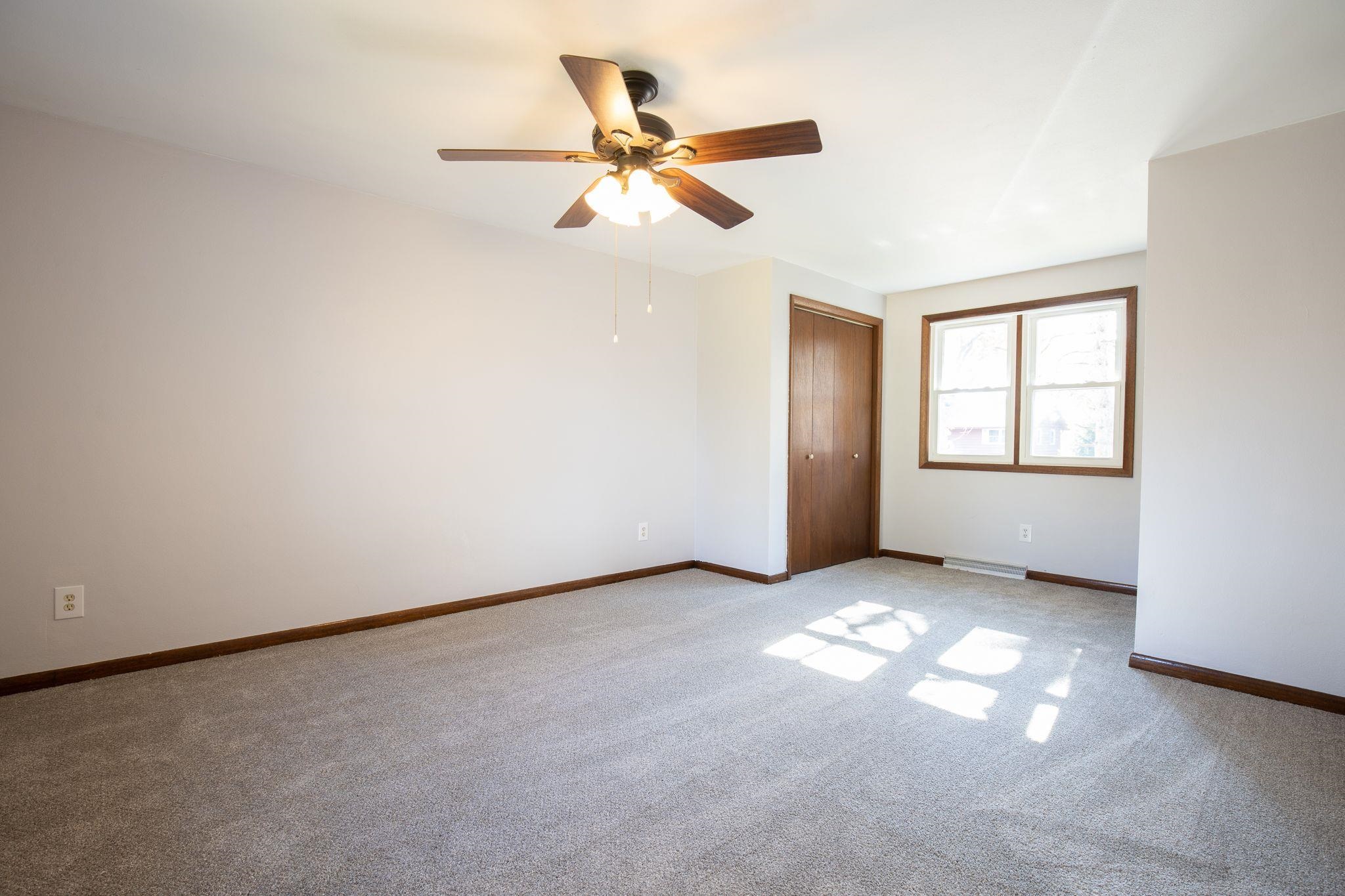 4962 Braewild Road Rockford, IL 61107 - Photo 12 of 20 an empty room with windows and fan