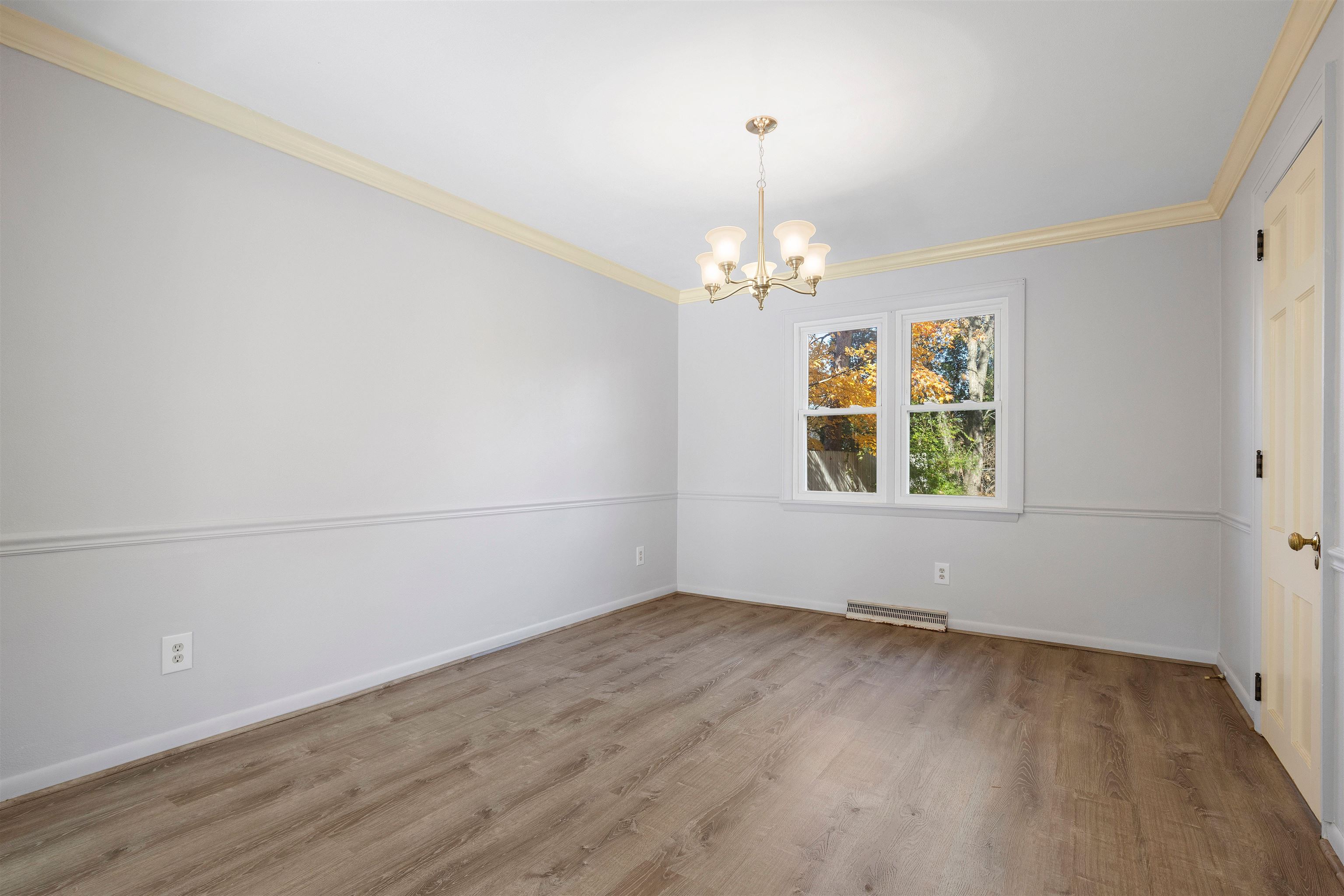 4962 Braewild Road Rockford, IL 61107 - Photo 4 of 20 an empty room with wooden floor chandelier and windows