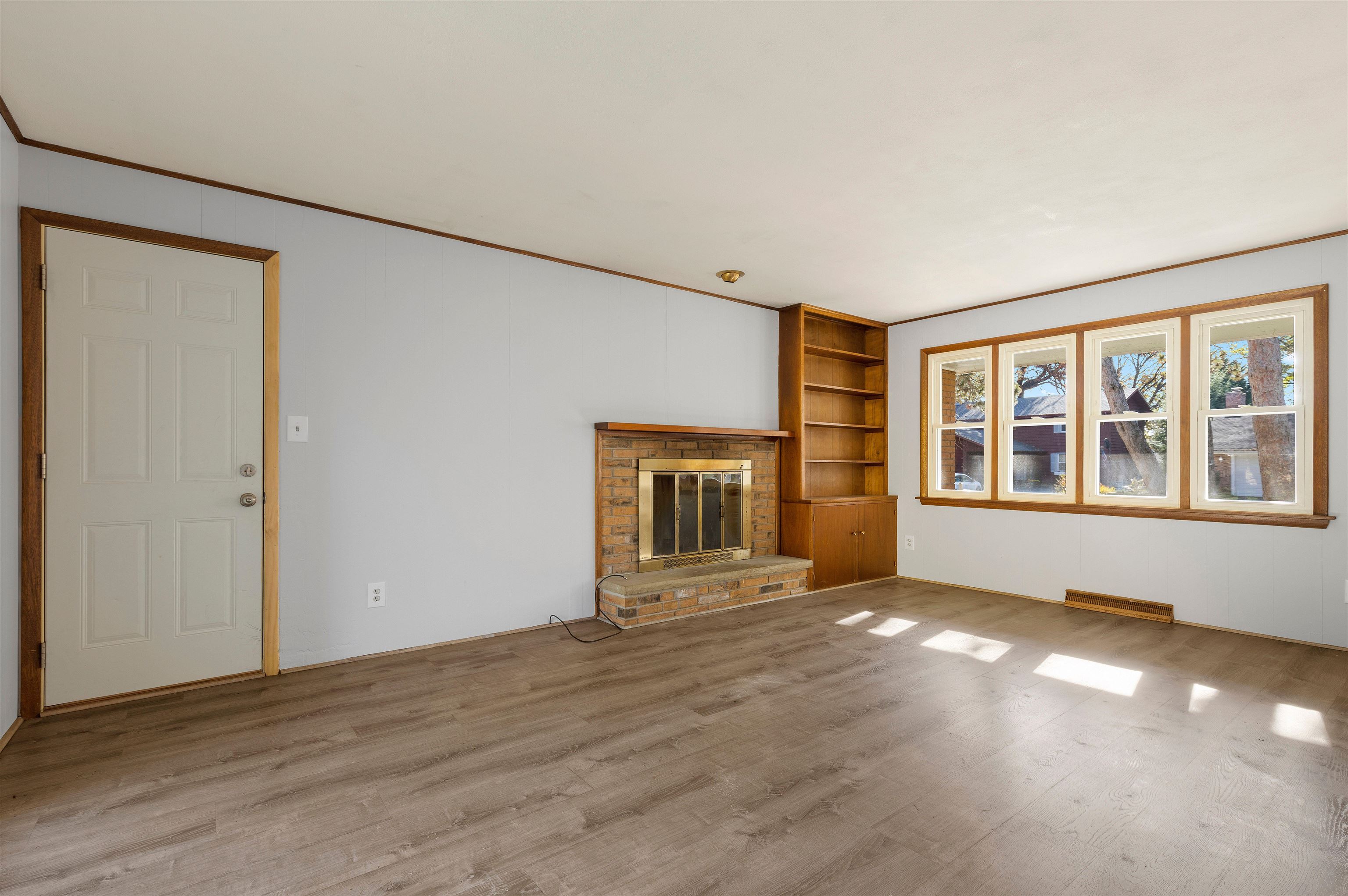 4962 Braewild Road Rockford, IL 61107 - Photo 7 of 20 a view of an empty room with wooden floor and a window