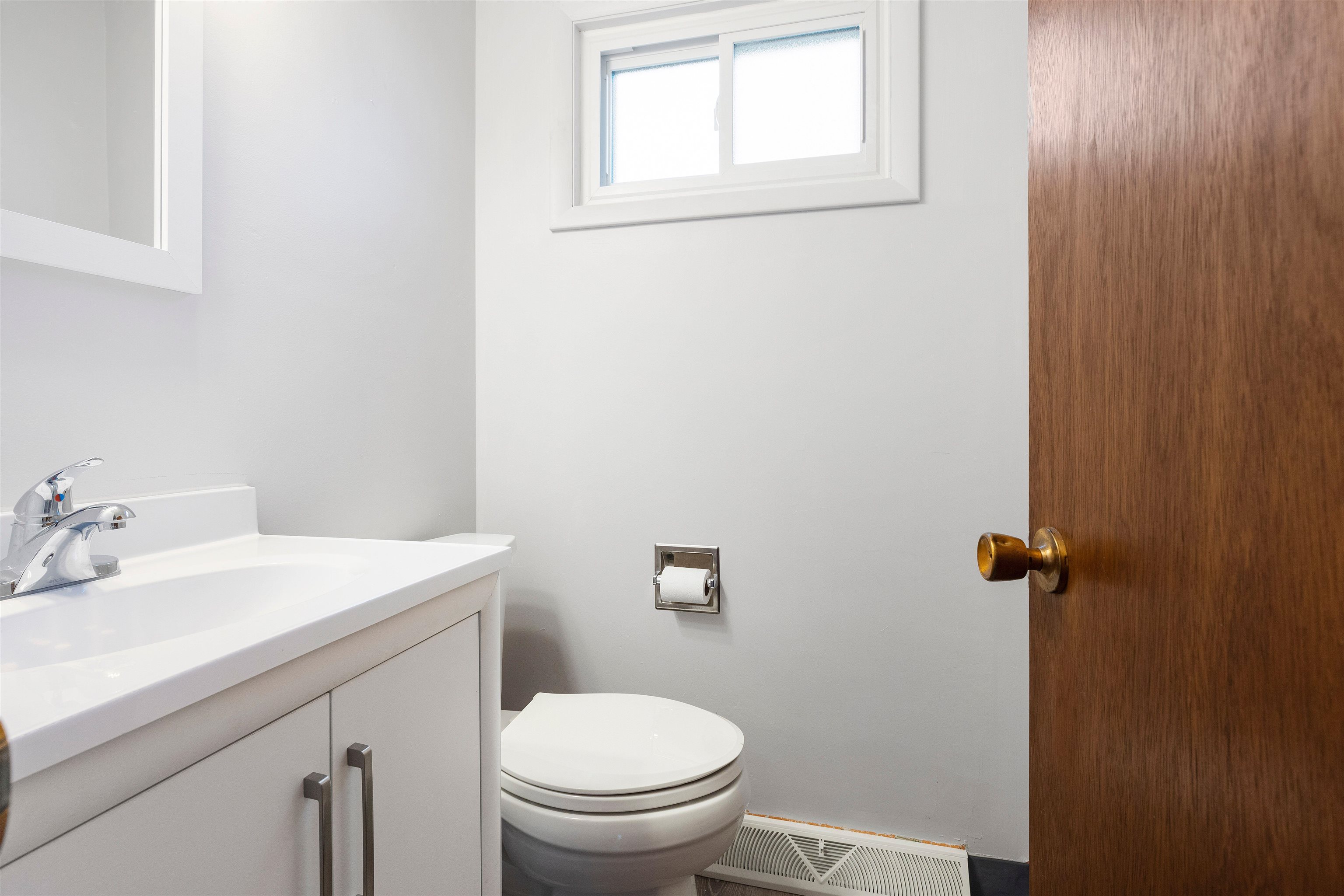 4962 Braewild Road Rockford, IL 61107 - Photo 9 of 20 a bathroom with a sink a toilet and a mirror