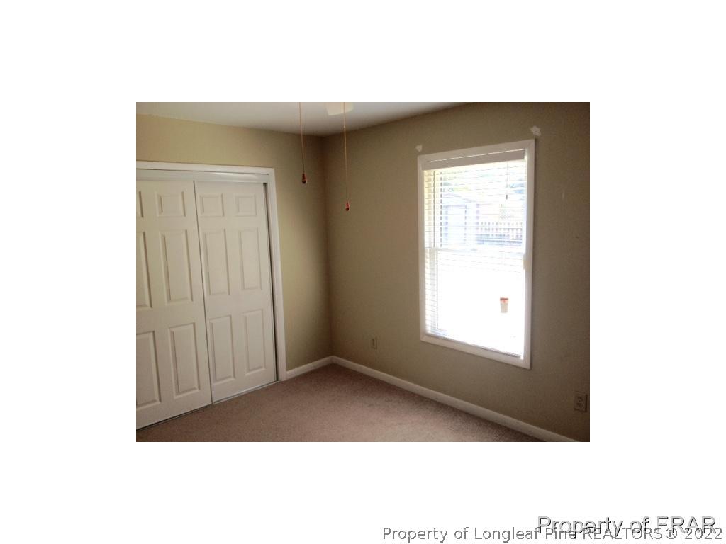 1786 Arrow Ridge Way Fayetteville, NC 28304 - Photo 11 of 17 a view of an empty room with wooden floor and a window