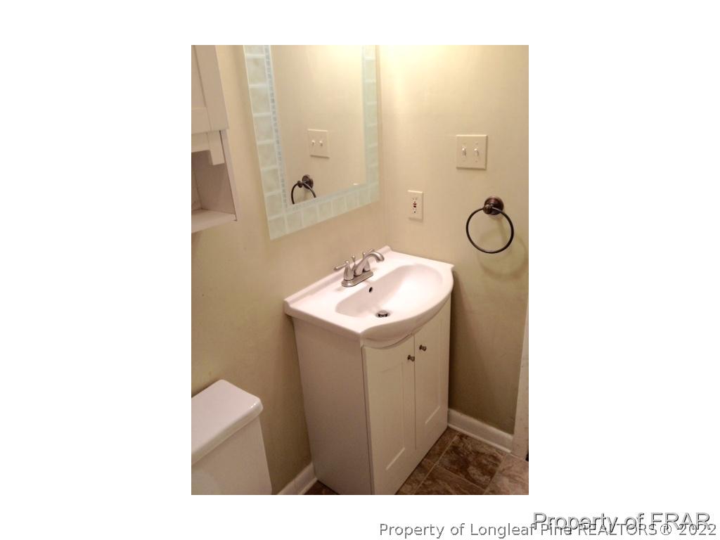 1786 Arrow Ridge Way Fayetteville, NC 28304 - Photo 13 of 17 a bathroom with a sink a toilet and mirror