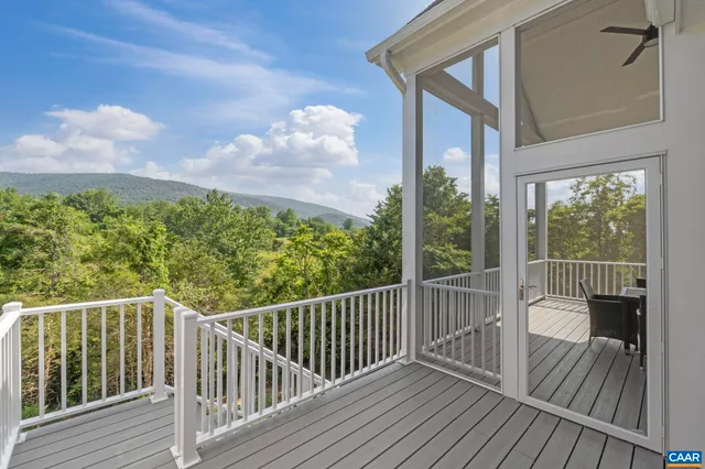 a kitchen with stainless steel appliances granite countertop a refrigerator a sink a stove a dining table and chairs