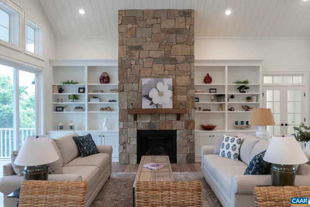 a kitchen with stainless steel appliances kitchen island granite countertop a refrigerator a sink dishwasher a dining table and chairs with wooden floor