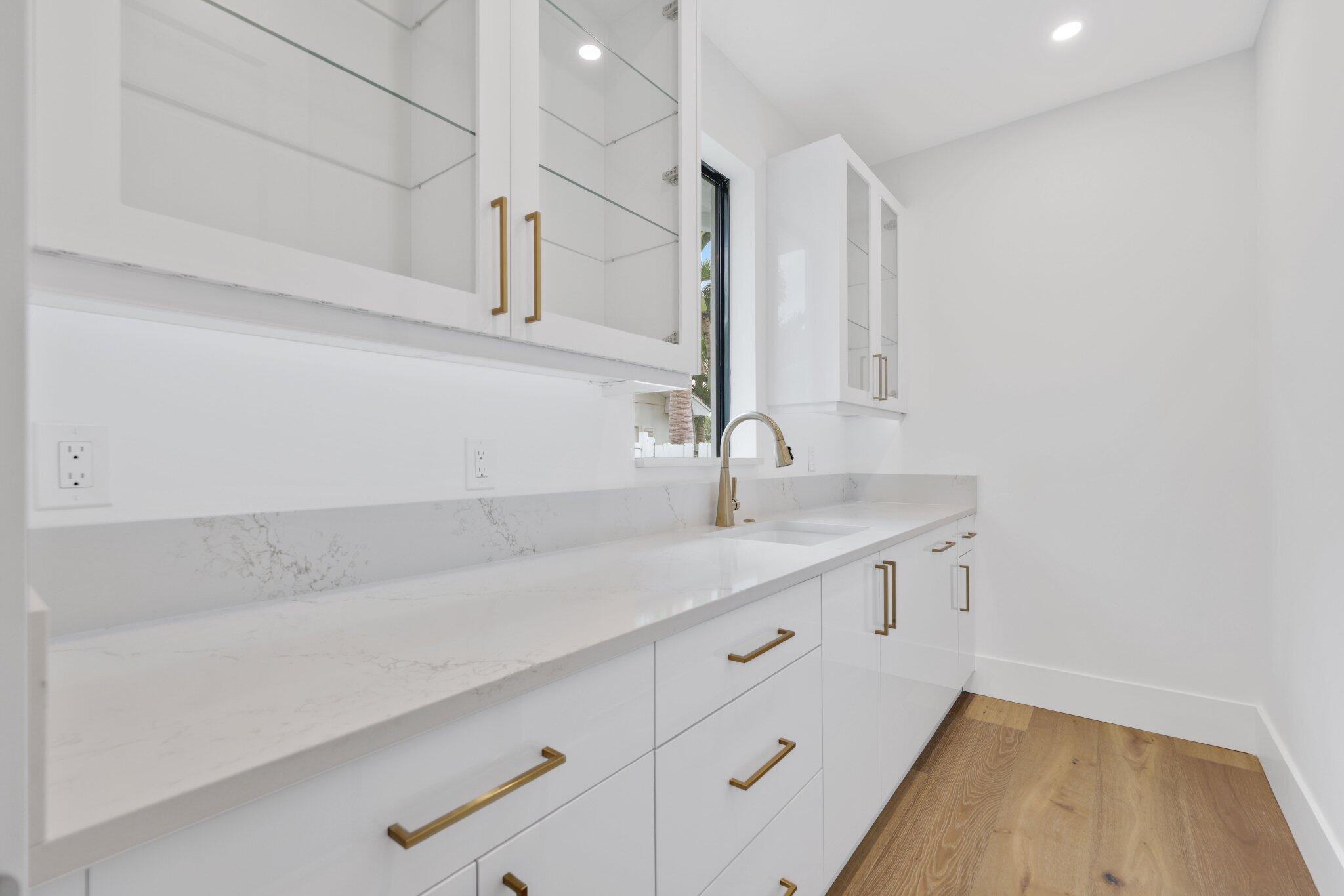 1211 Gulfstream Way Singer Island, FL 33404 - Photo 14 of 54 a kitchen with a sink and cabinets