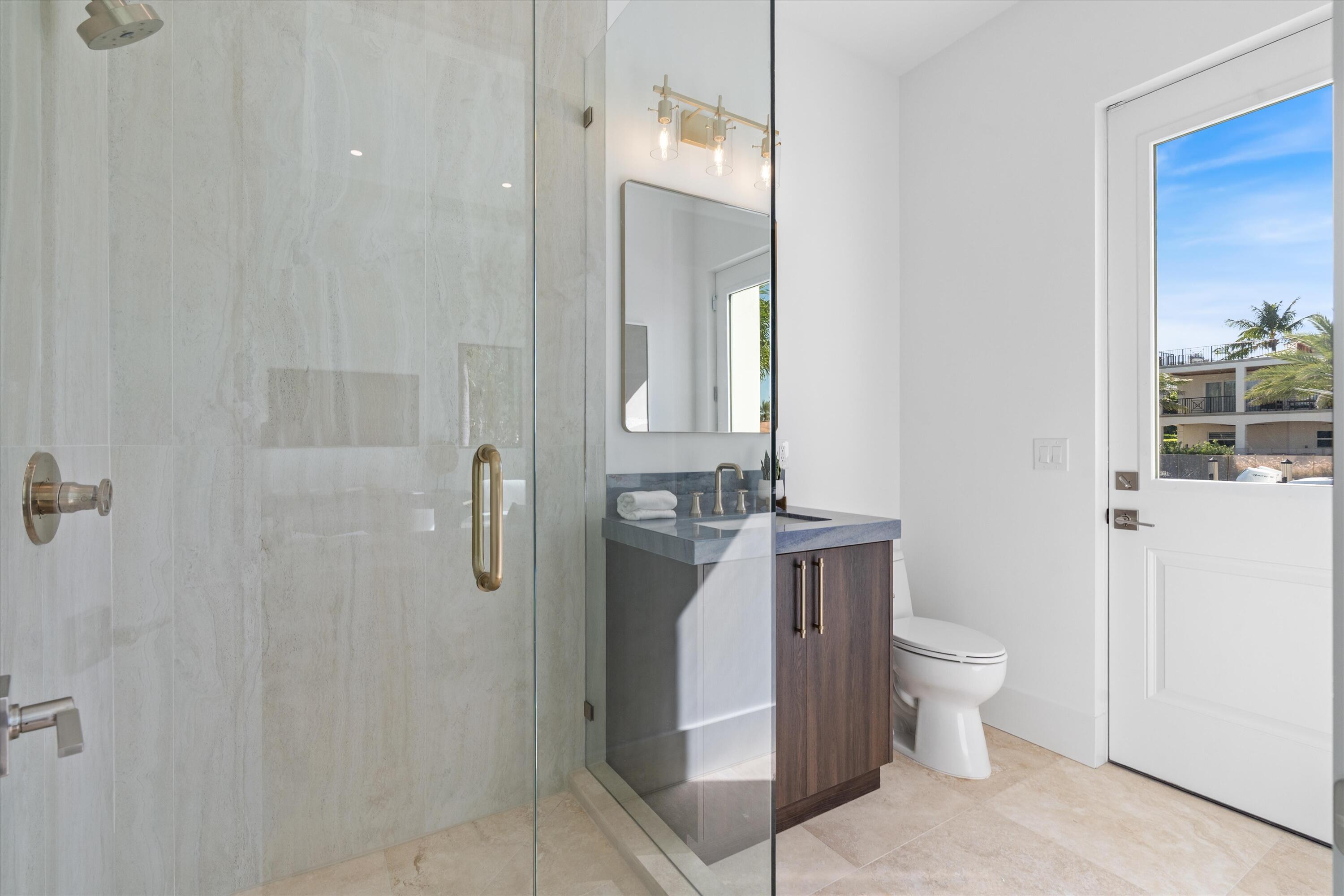 1211 Gulfstream Way Singer Island, FL 33404 - Photo 17 of 54 a bathroom with a toilet sink and shower