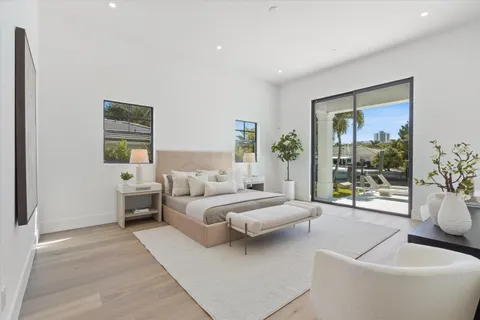 a bedroom with a bed and glass window