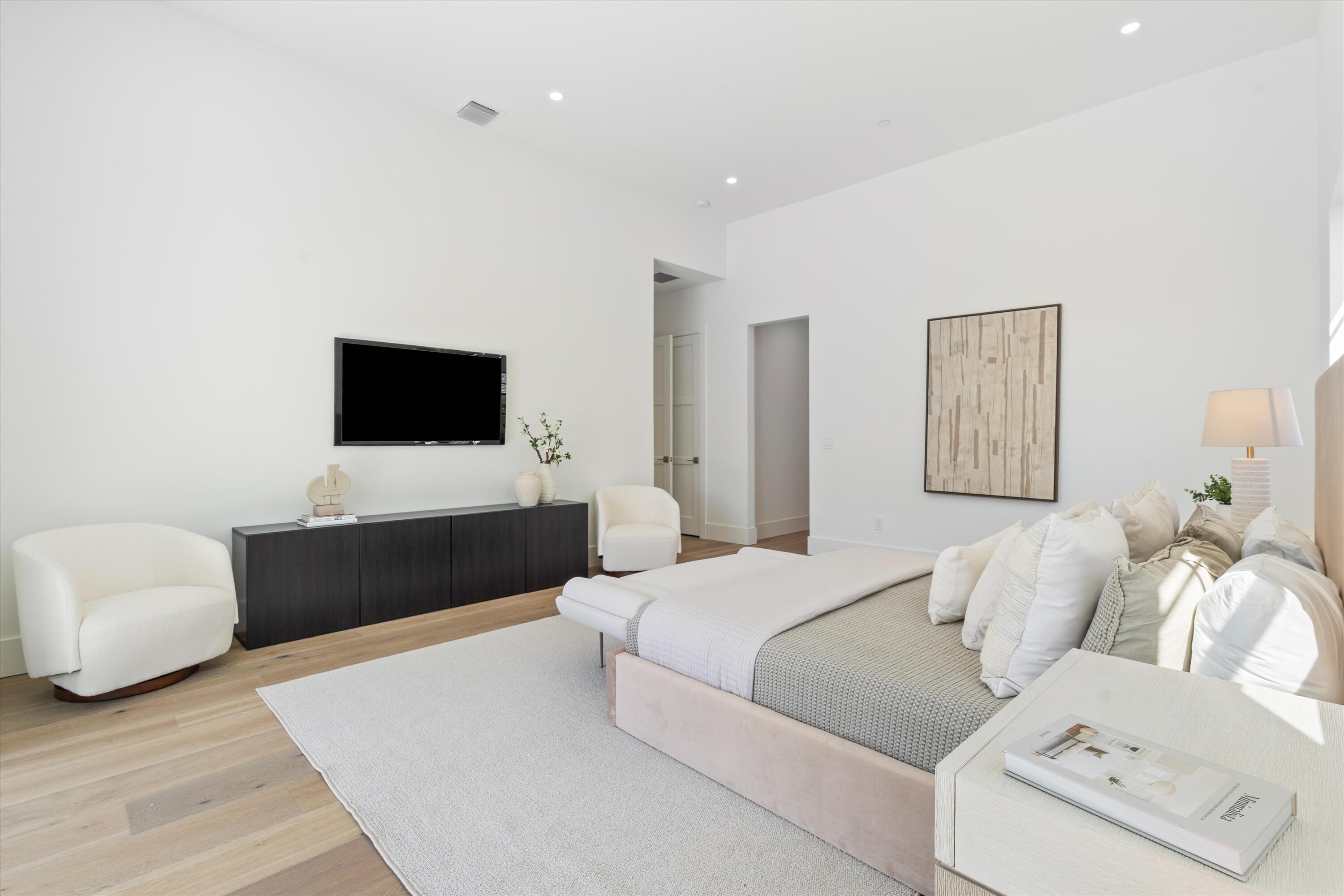 1211 Gulfstream Way Singer Island, FL 33404 - Photo 20 of 54 a bedroom with a bed and a flat screen tv