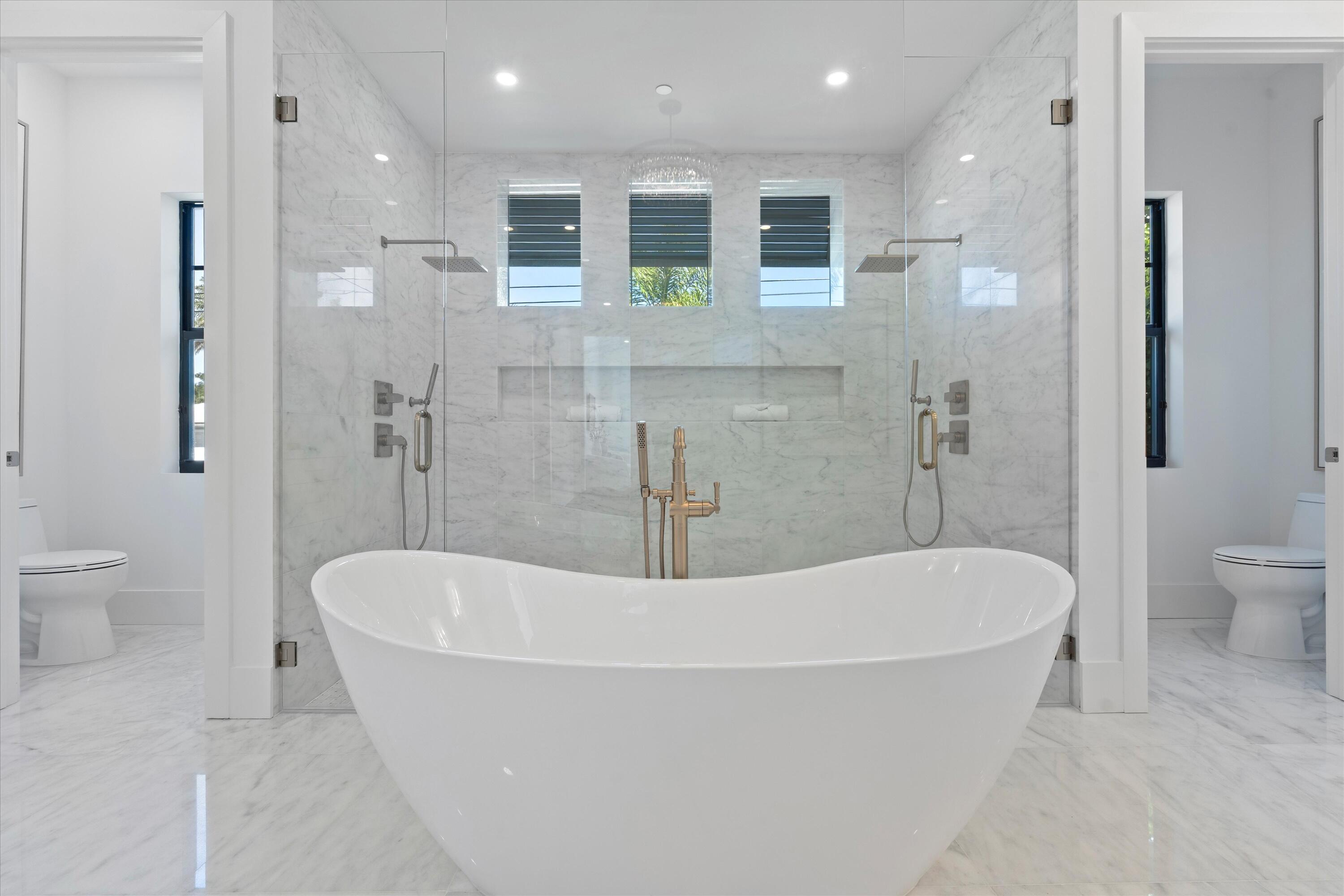 1211 Gulfstream Way Singer Island, FL 33404 - Photo 23 of 54 a white bath tub sitting next to a white toilet