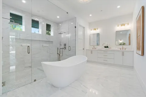 a spacious bathroom with a bathtub and shower