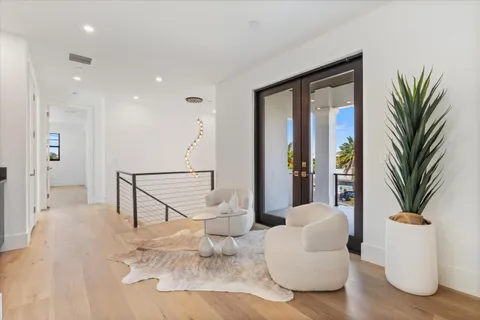 a living room with furniture a refrigerator and kitchen view