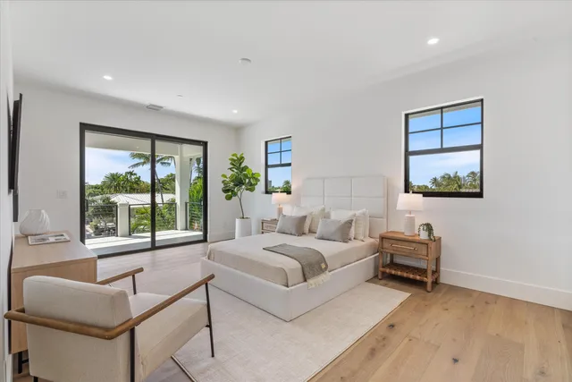 a bedroom with furniture and a flat screen tv