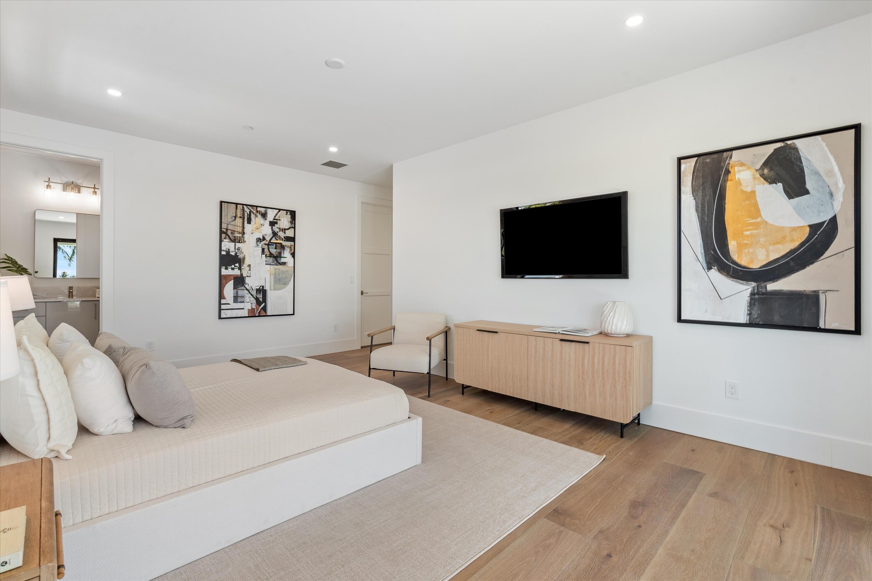 1211 Gulfstream Way Singer Island, FL 33404 - Photo 36 of 54 a bedroom with a bed and a flat screen tv