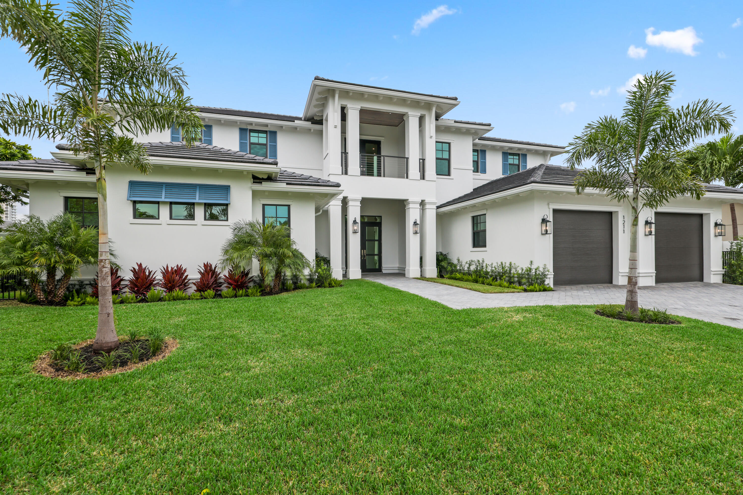 1211 Gulfstream Way Singer Island, FL 33404 - Photo 44 of 54 a front view of a house with a garden and plants