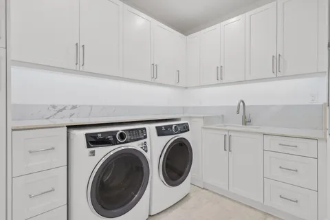 a aerial view of a house next to a yard