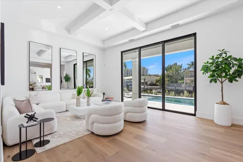 a living room with furniture and a large window with outer view