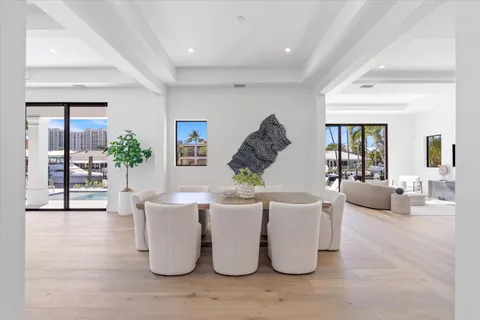 a kitchen with stainless steel appliances a stove a sink cabinets and wooden floor