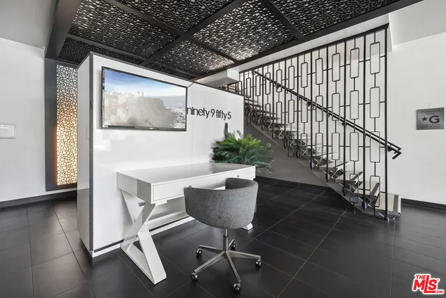a view of a hallway with wooden floor and stairs