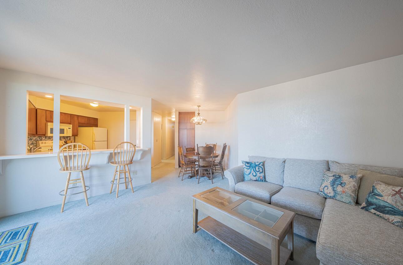 585 Hawthorne Street, Unit 103 Monterey, CA 93940 - Photo 11 of 30 a living room with furniture and a large window