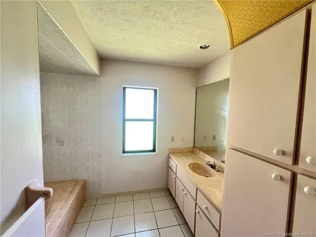 a bathroom with a bathtub sink and mirror