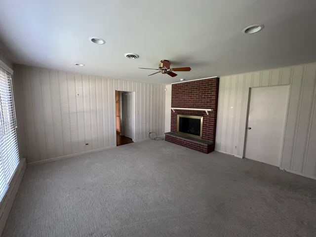 a view of empty room with a fireplace