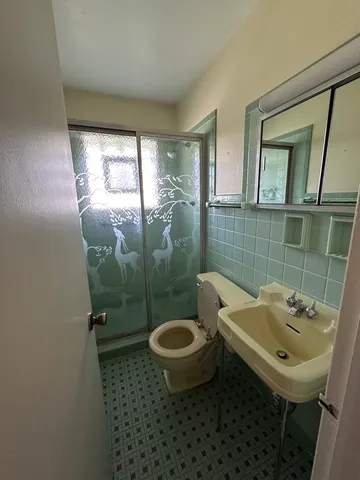 a bathroom with a sink toilet and shower