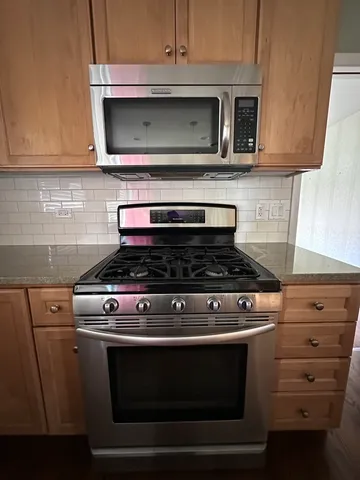 a stove top oven sitting inside of a kitchen