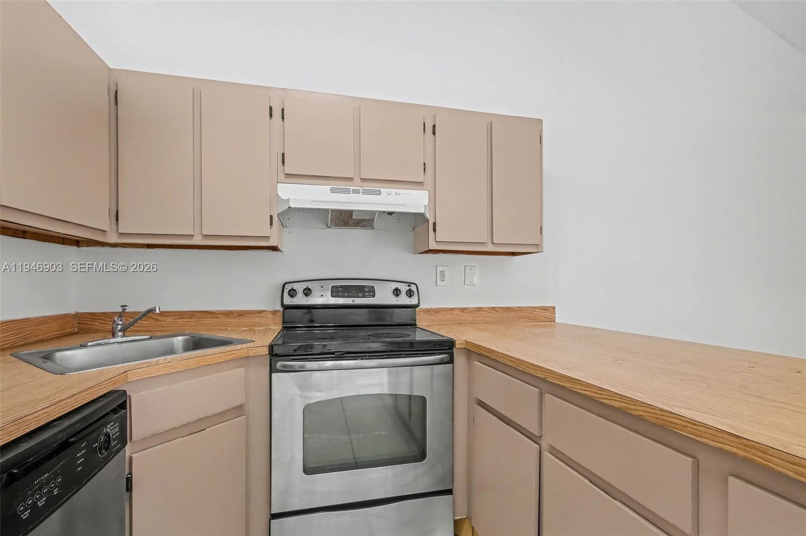 5510 Northwest 24th Street Lauderhill, FL 33313 - Photo 11 of 25 a kitchen with cabinets appliances a sink and a counter top