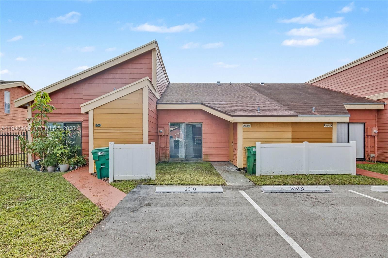 5510 Northwest 24th Street Lauderhill, FL 33313 - Photo 24 of 25 a front view of a house with a yard and garage