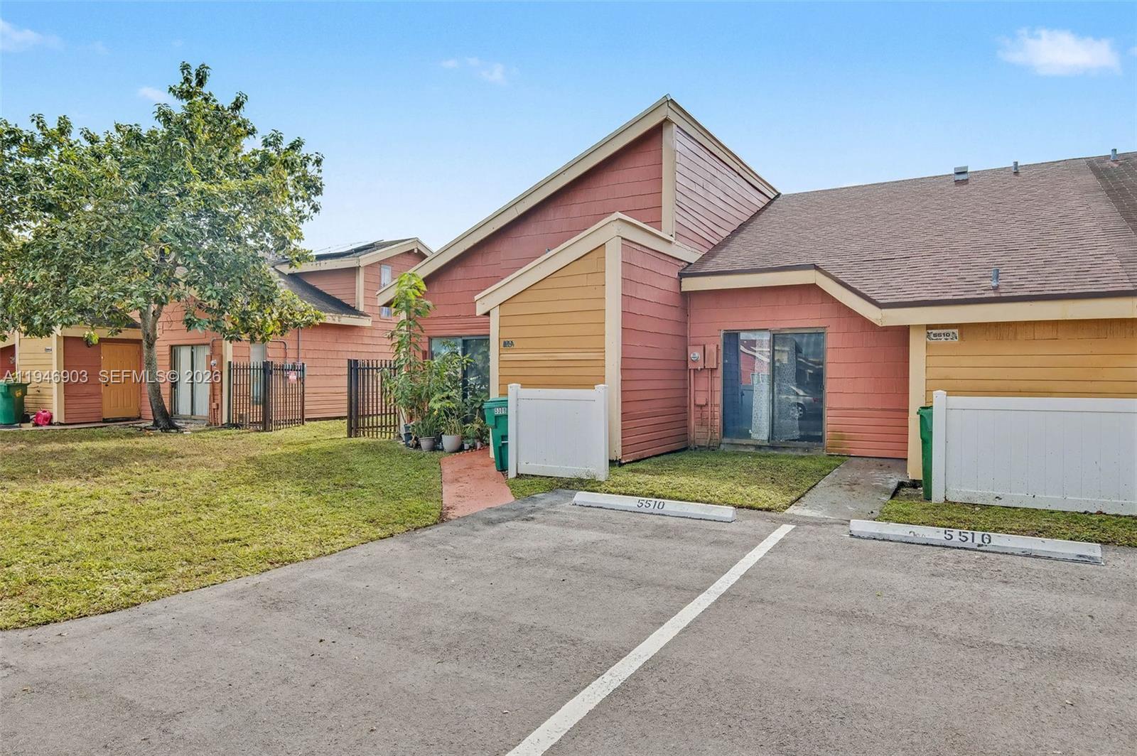 5510 Northwest 24th Street Lauderhill, FL 33313 - Photo 25 of 25 a front view of a house with a yard and garage