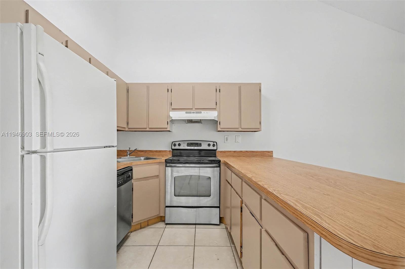 5510 Northwest 24th Street Lauderhill, FL 33313 - Photo 10 of 25 a kitchen with a stove sink and cabinets